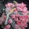 A charming and elegant basket filled with beautiful pink roses, symbolizing grace