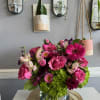 Pink and magenta flower arrangement in a glass vase