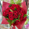 A classy wrapped bouquet with 18 red roses and greenery.  Just