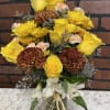 Yellow and white mixed bouquet with chrysanthemums and roses in a glass vase