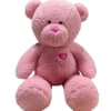 Pink teddy bear plush toy with a heart on its chest