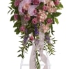 Standing floral spray with pink roses and lavender flowers on an easel