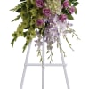 Tall floral spray with pink roses and lavender orchids on a white stand