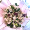 This elegant bouquet features premium cream and blush roses accented with rich