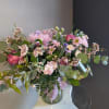 This beautiful flower arrangement of fresh mixed seasonal blooms is made by