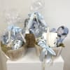 Gift baskets with blue floral items wrapped in clear cellophane and ribbon