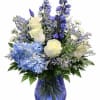 Blue and white floral arrangement in a cobalt glass vase