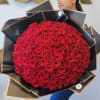 Large bouquet of red roses wrapped in black paper