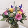 Blossom-filled spring custom arrangement, cheery but elegant, surrounded by a assortment of