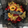 Bouquet of red roses and sunflowers with black wrapping and gold butterfly accents