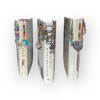 Three decorated book spines with beaded charms hanging from them