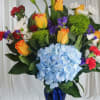 Beautiful blooms such as orange roses , lilies and alstroemeria along with