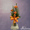 Three orange roses with vase and greenery and filler.