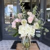 Pink roses and white hydrangeas in a glass vase