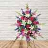 Purple Glads, Purple Larkspur, Hot Pink Roses, and white lilies in this