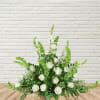 Bells of Ireland, White Snapdragons, &amp; White Roses in this tall funeral