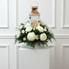 All white blooms surrounding a beautiful keepsake lantern with varying sentiments. All