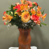 A vibrant burst of orange blooms arranged to bring instant sunshine to