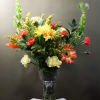 A lively mix of Bells of Ireland, carnations, a cheerful gerber daisy