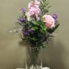 A charming mix of pink and purple blooms arranged in a vase