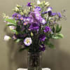 A rich and elegant bouquet featuring shades of purple blooms arranged in