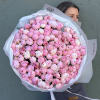Large bouquet of pink peonies wrapped in white paper