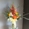 This beautiful flower arrangement of fresh mixed seasonal blooms is made by