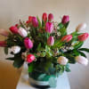 Bouquet of pink and white tulips in a round vase