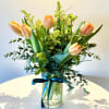 Inspired by the glow of natural light, this arrangement features vibrant tulips
