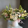 This beautiful flower arrangement of fresh mixed seasonal blooms is made by