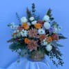A lush and elegant arrangement that blends the warmth of autumn with