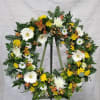 Select this 22" wreath that includes gerbera daisies, mums and more. 