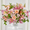 Blooming pink lilies are a standout in this tabletop arrangement suitable for