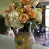 Peach Oriental Lilly&rsquo;s, Peach Roses, White Hydrangeas, Yellow Stock, Seeded Eucalyptus.