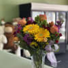 Yellow Gerberas, Orange roses, Purple Stock, Orange Tulips, Red Mini Carnations, Solid