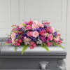 Colorful, full and lush, this extraordinary casket spray makes a memorable and