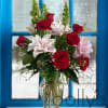 An elegant display of lilies and roses made to say I love