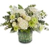 White and green floral arrangement in a glass vase