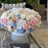 Pink and white Roses, set in soft blue Hydrangea, finished with white