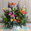 Colorful flower basket with tulips, daisies, and butterflies
