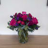 This vibrant floral arrangement features bold pinks and purples perfect for Birthdays