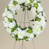 "Pure Serenity: A Tribute in White" is an elegant wreath that symbolizes