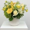 Beautiful white and yellow blooms accented with greenery 