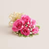 A vibrant and stylish wrist corsage featuring hot pink spray roses arranged