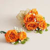 A vibrant and coordinated floral set featuring an orange spray rose wrist