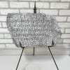 Decorative memorial plaque on a metal stand with a Bible verse