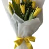 Yellow tulip bouquet wrapped in white paper with a yellow ribbon