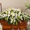 A luxurious and elegant all-white casket spray designed to honor a cherished
