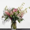 A vibrant tropical arrangement featuring a curated blend of pink blooms and