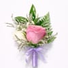 Soft, romantic, and beautifully refined, this elegant boutonniere features a delicate pink